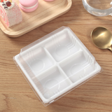 FG136 | 4 Compartment Plastic Mini Cake White Box W/ Clear Anti-Fog Lid | 4.84x4.84x1.77" - on the table