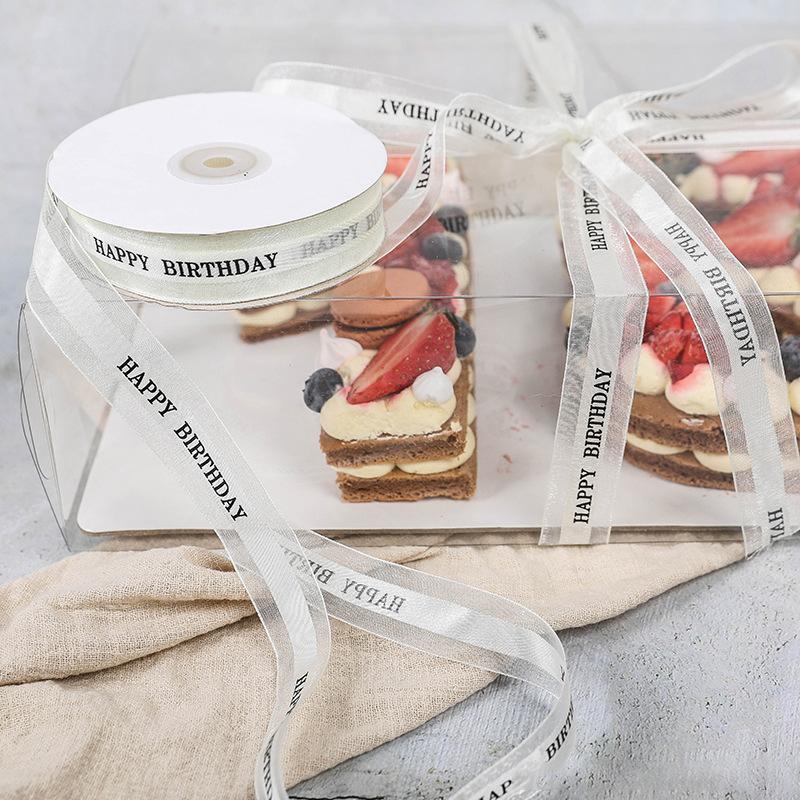 1" Happy Birthday Fabric Ribbon white on a cake pad