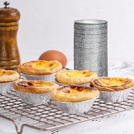 3.5" Aluminum Foil Egg Tart Mold Baking Cup on a rack stacked up