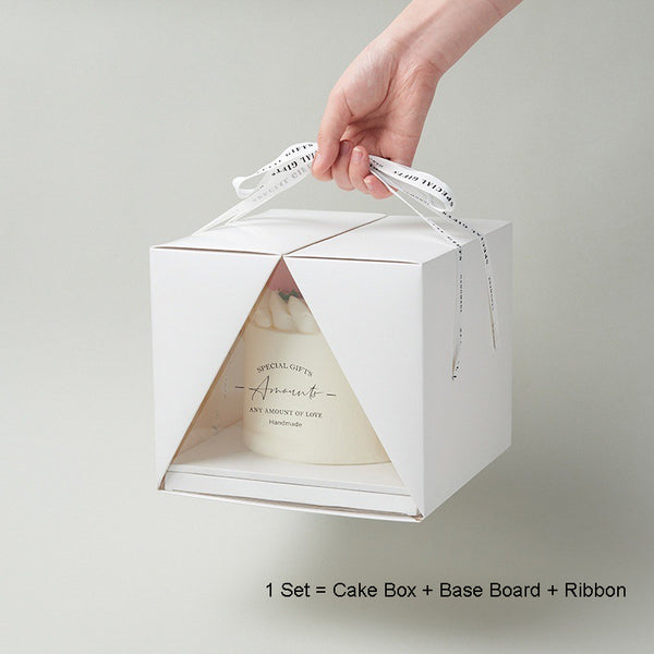 White cake box with cake inside and a ribbon