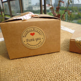 1.5" Thank You Round Kraft Sticker attached to a gift box